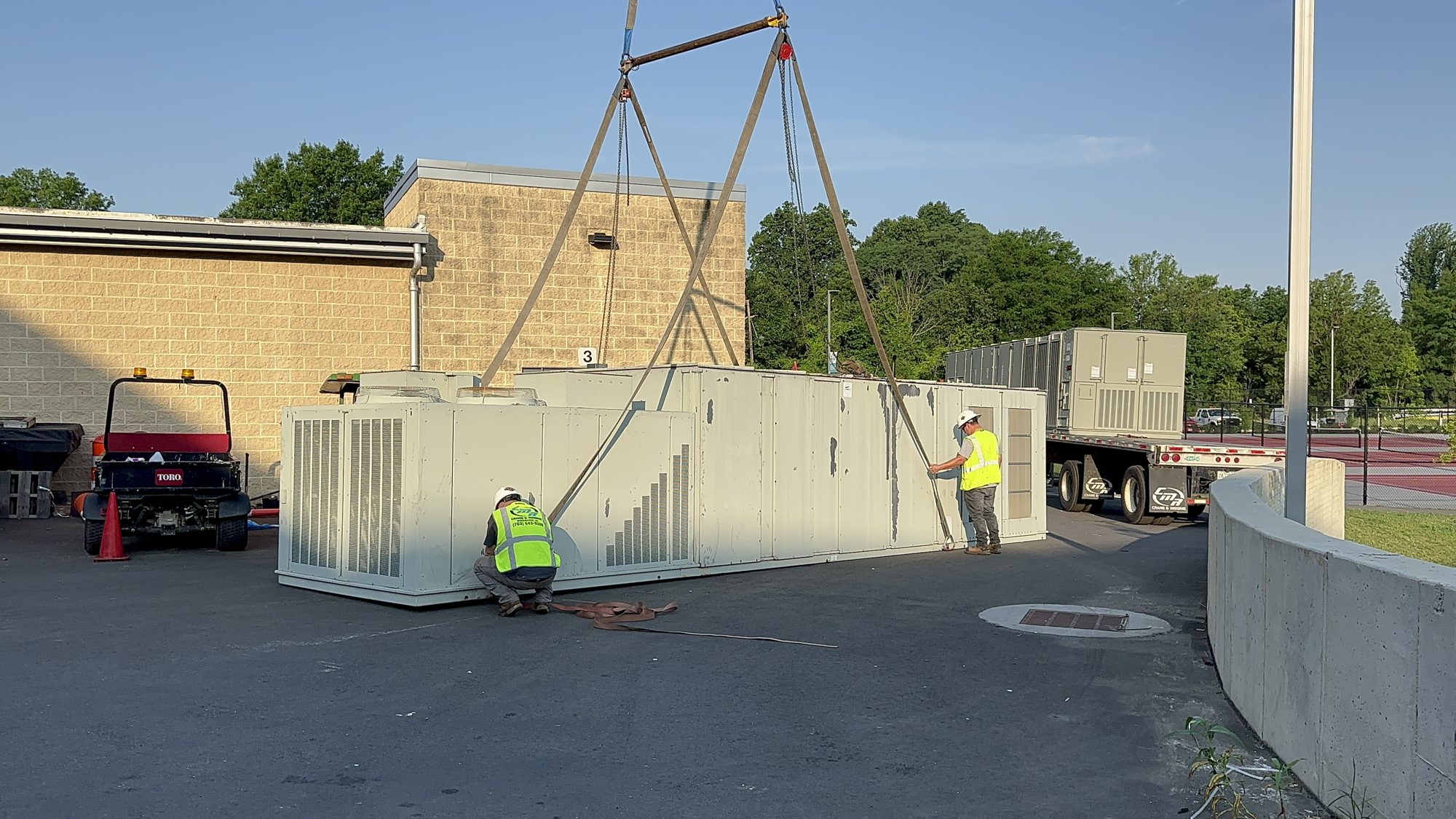 Crew rigging the old rooftop unit after removal