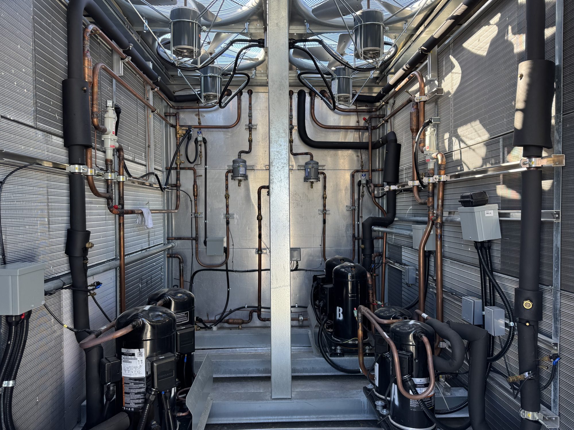 Inside a Trane rooftop unit compressor section with Copeland scroll compressors