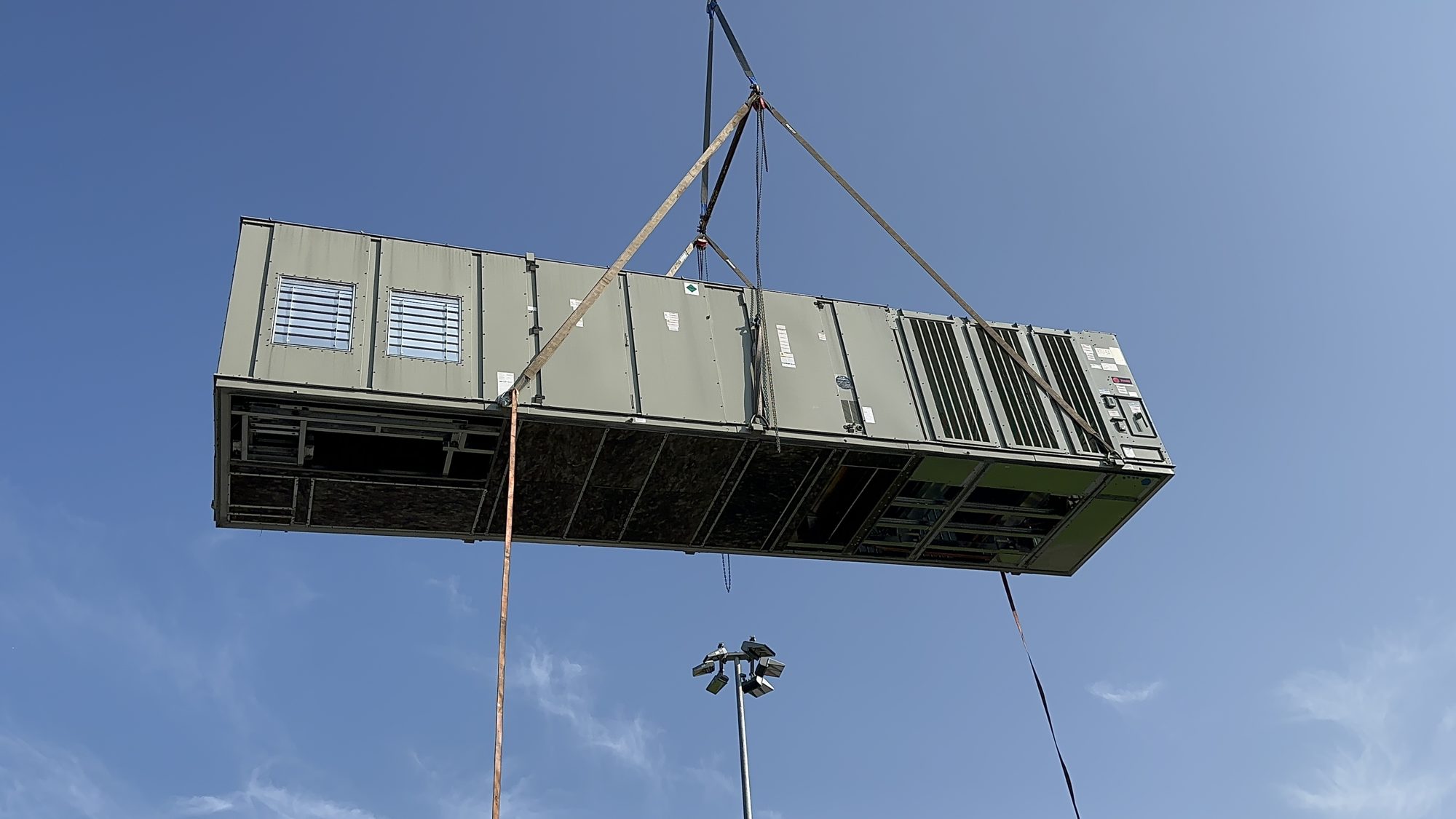 Trane rooftop unit lifted by crane during installation